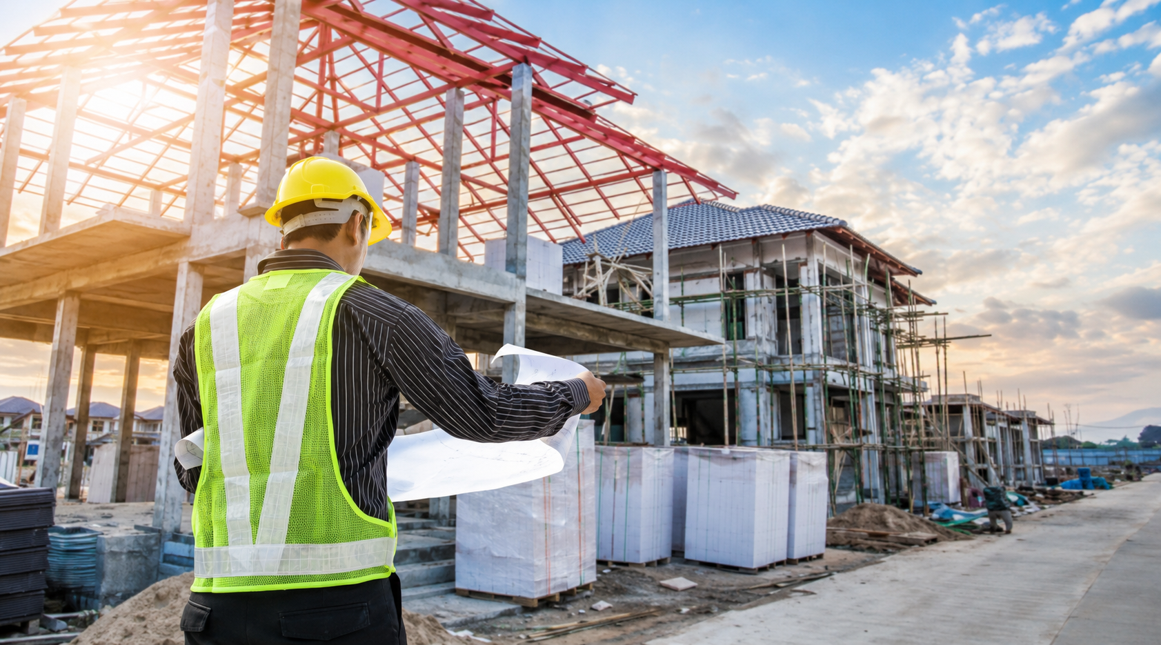 Construction site builder reviewing plans